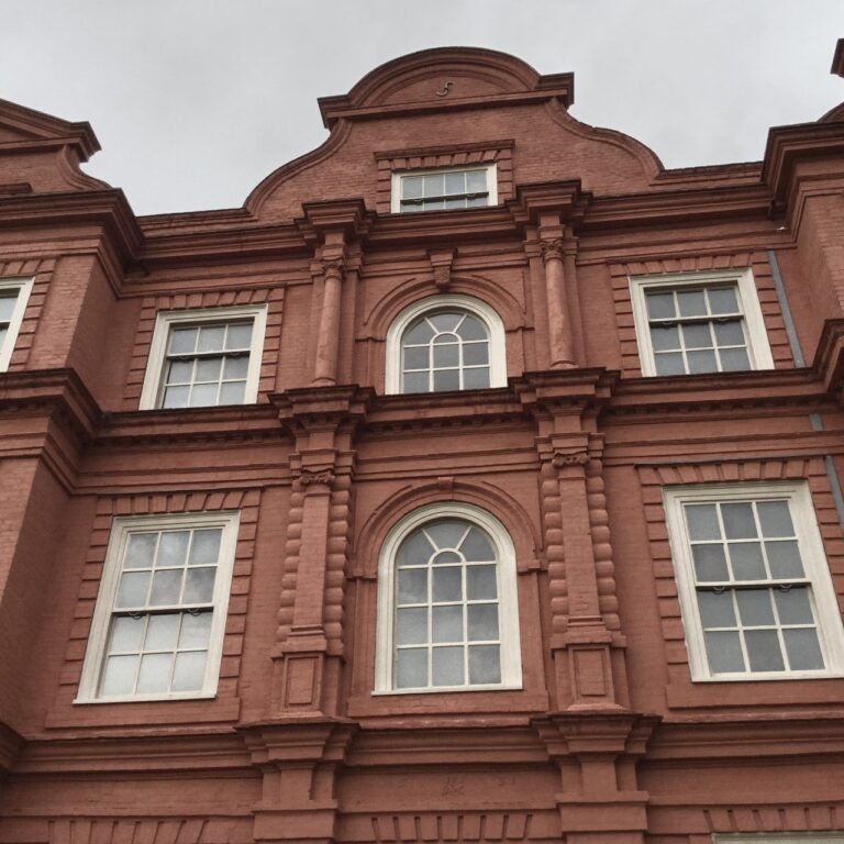 The carved central bay and tall sash windows of the palace front, Kew Palace