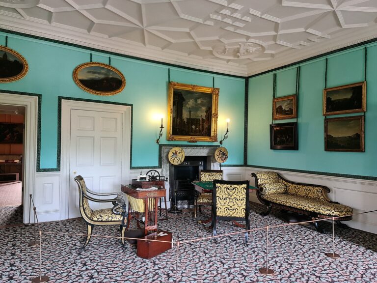 The Queen's Boudoir, turquoise walls hung with gilt-framed paintings, Kew Palace