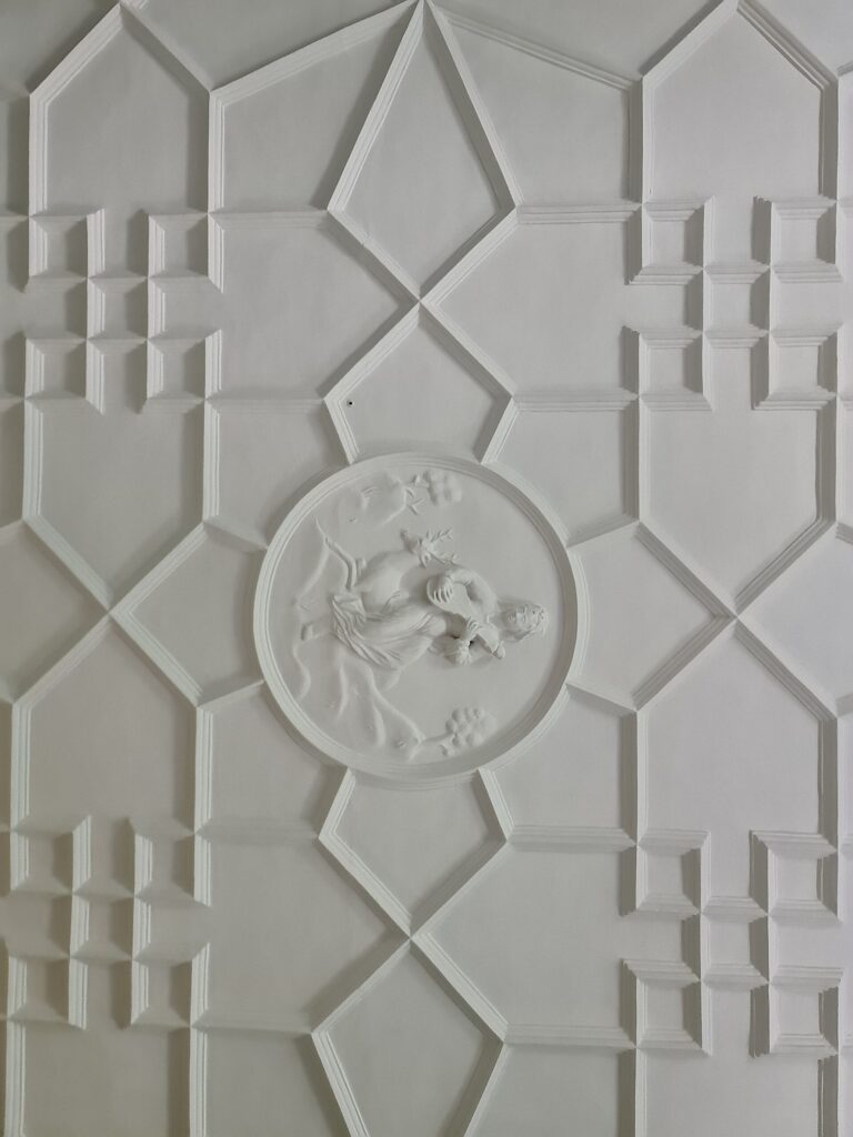 The geometric plasterwork ceiling and its central cherub roundel, Kew Palace