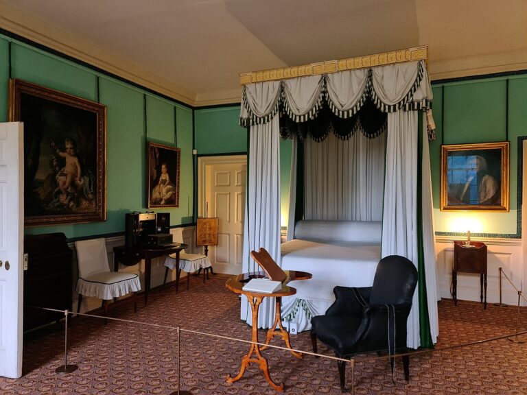 A green-draped four-poster in a royal bedchamber, Kew Palace