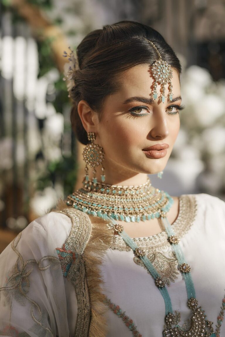 An ivory bridal look with a turquoise and gold necklace set, Khushi The Makeup Artist