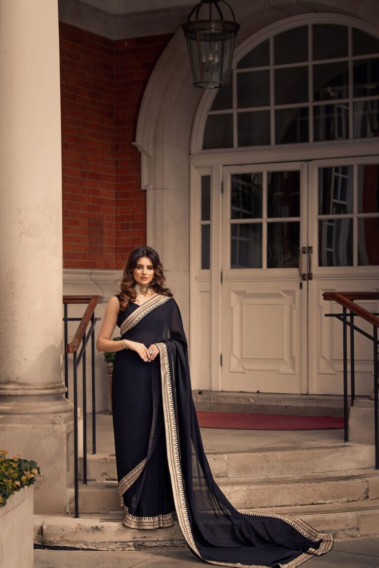 A navy saree, draped and pinned, before a panelled door, Khushi The Makeup Artist