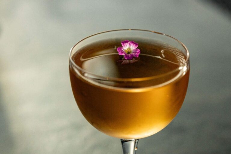 Cocktail garnished with an edible flower, Kimpton BEM Budapest