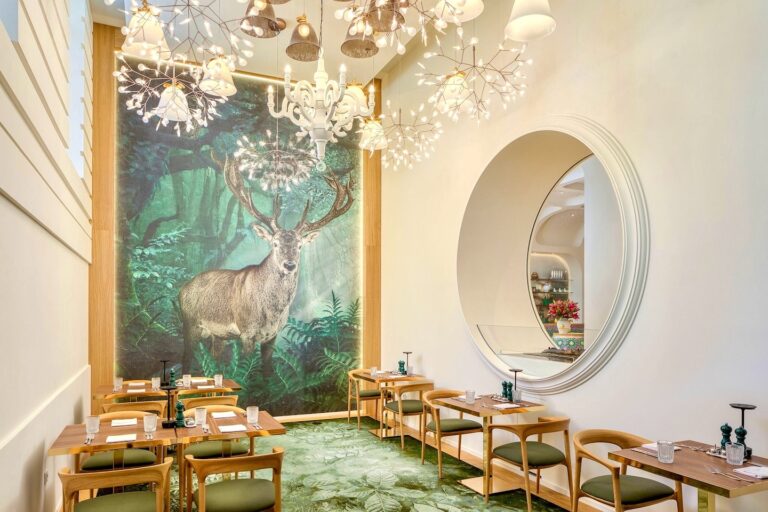 Dining room with a stag mural and long tables, Kimpton BEM Budapest