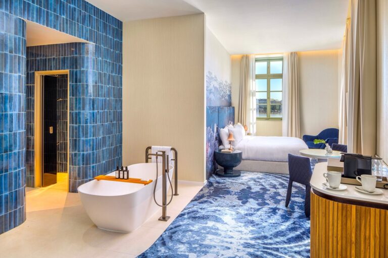 Blue-themed room with freestanding tub, Kimpton BEM Budapest