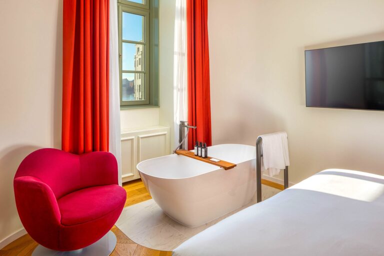 Room with red curtains and freestanding tub, Kimpton BEM Budapest