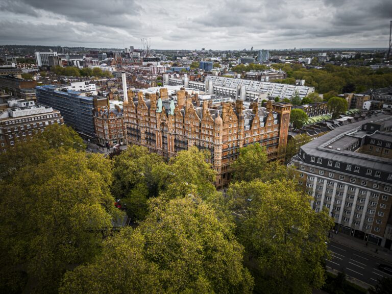 The hotel from the air, filling a full block on the east side of Russell Square with the trees of the square in the foreground, Kimpton Fitzroy London