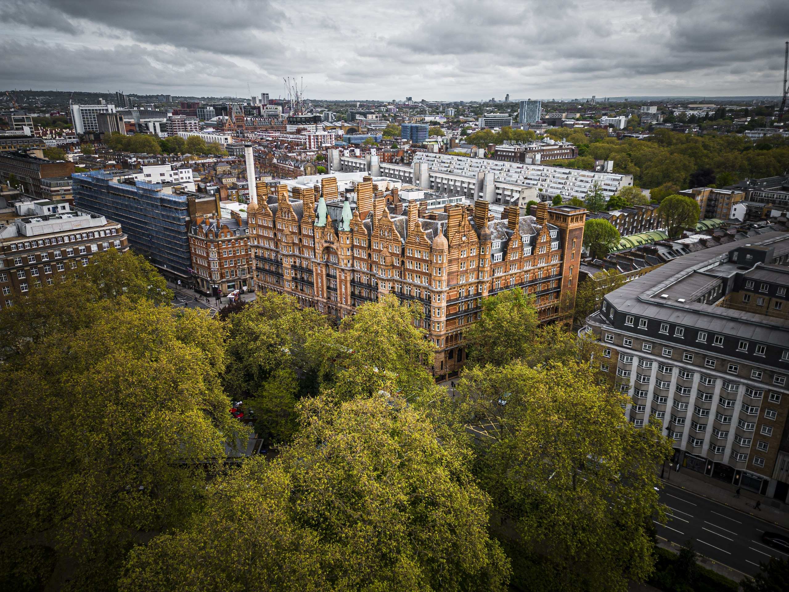 The hotel from the air, filling a full block on the east side of Russell Square with the trees of the square in the foreground, Kimpton Fitzroy London