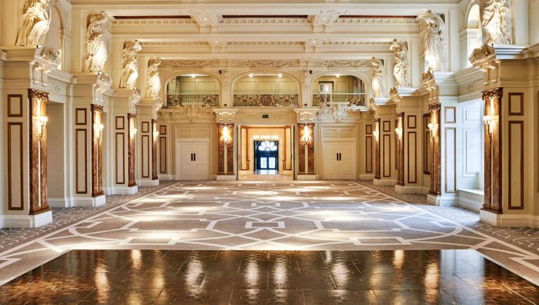 The Grade II listed Ballroom empty, showing the gilded coffered ceiling, marble pilasters, sculpted figures and patterned floor, Kimpton Fitzroy London