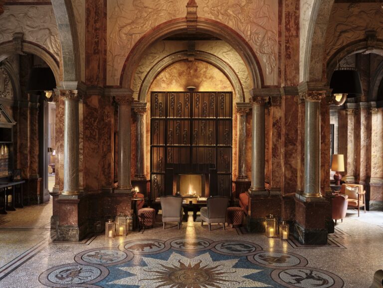 The marble lobby with its original Zodiac mosaic floor, arches and a fireplace at the far end, Kimpton Fitzroy London