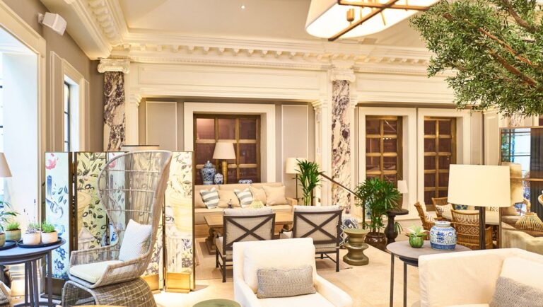 A seating area in Palm Court with marble columns, screens and a peacock chair, Kimpton Fitzroy London