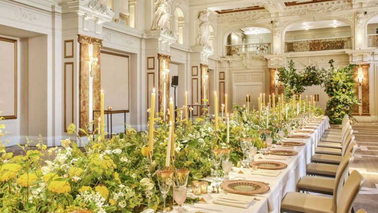 A long table running down the Ballroom with a low meadow of greenery and yellow flowers and gold candlesticks, Kimpton Fitzroy London