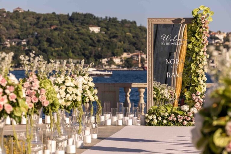 A floral welcome sign on a waterfront terrace, KM Events