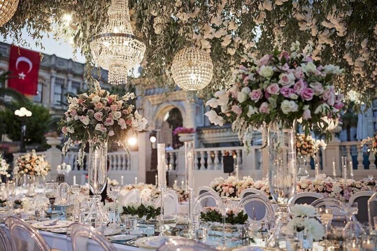 Wedding tables with flowers and crystal chandeliers beside a Turkish flag, KM Events