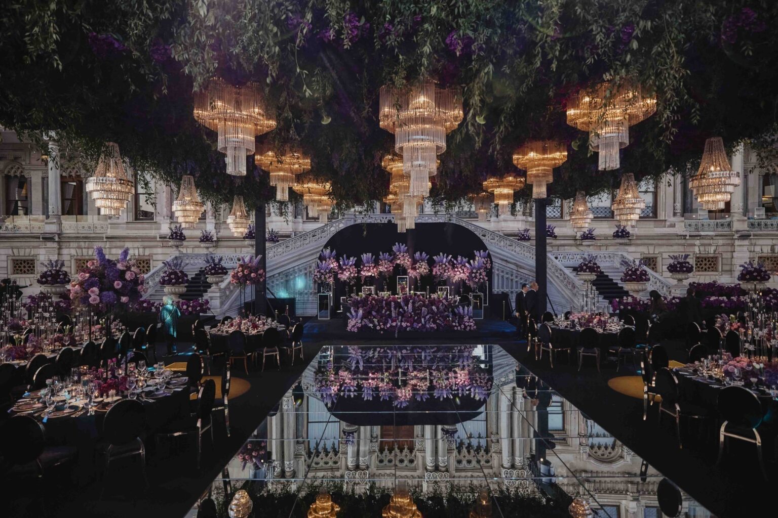 A candlelit wedding dinner in an ornate hall, KM Events