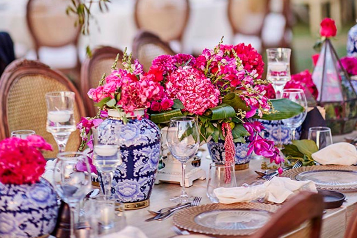 A table set with colourful flowers and blue and white china, KM Events