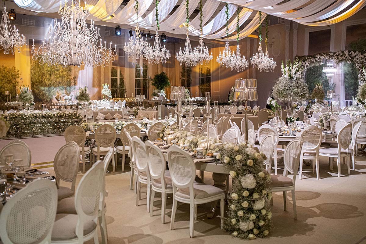 A banquet hall with tables dressed with flowers, KM Events