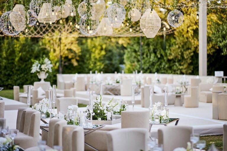 A white reception with greenery walls, KM Events