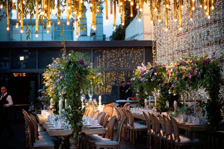 A palace reception with hanging flowers and lights, KM Events