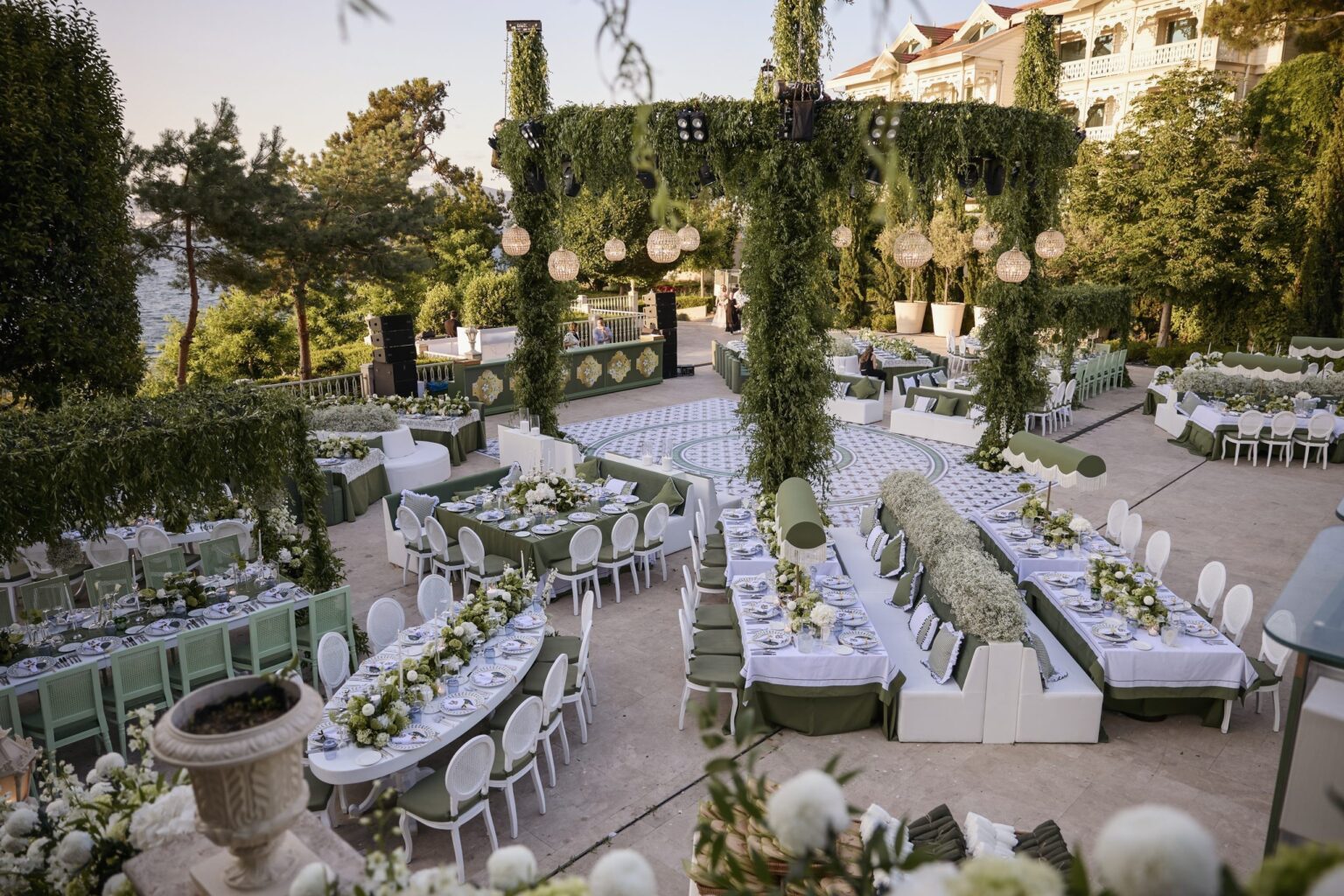 A garden wedding dinner with green arbours and long tables, KM Events