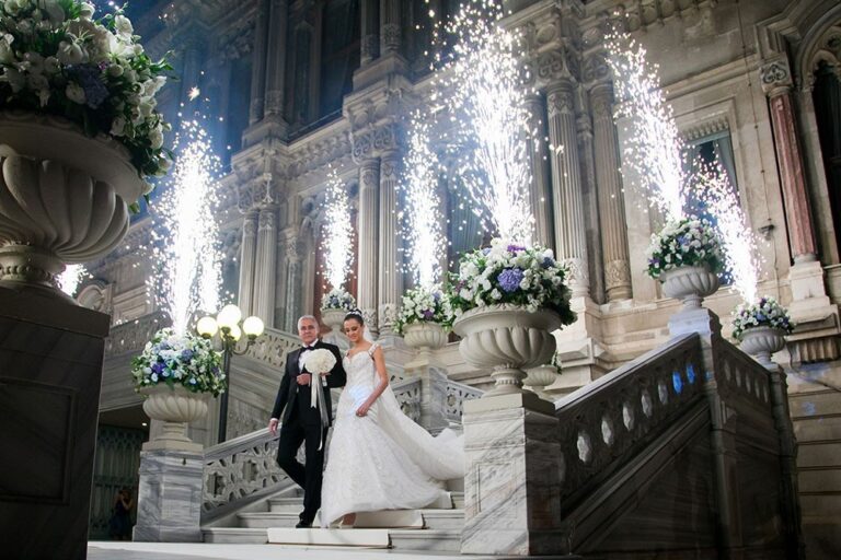 A bride and groom on a palace staircase with sparklers, KM Events