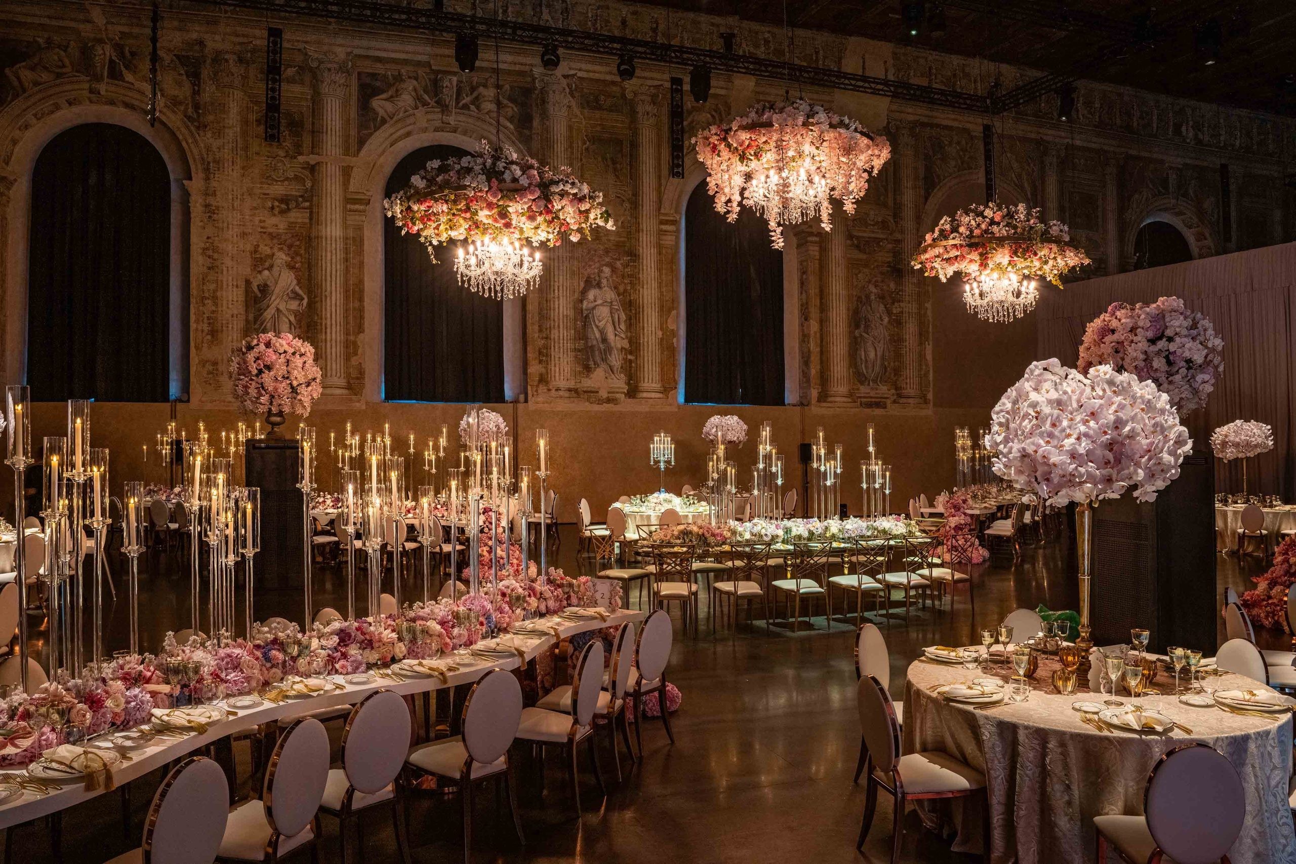 A wedding dinner in a historic hall with flower chandeliers, KM Events