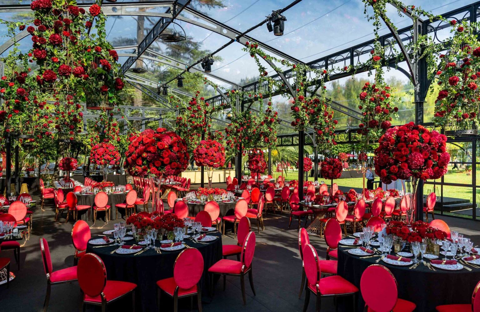 A red and white wedding dinner in a glass pavilion, KM Events
