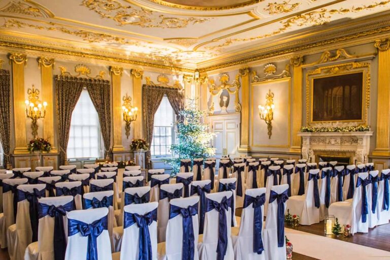 The Stucco Ballroom set for a ceremony with navy chair bows, Knowsley Hall