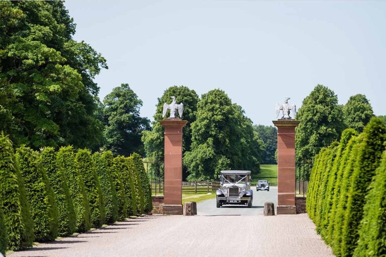A wedding car on the drive between the gate piers, Knowsley Hall