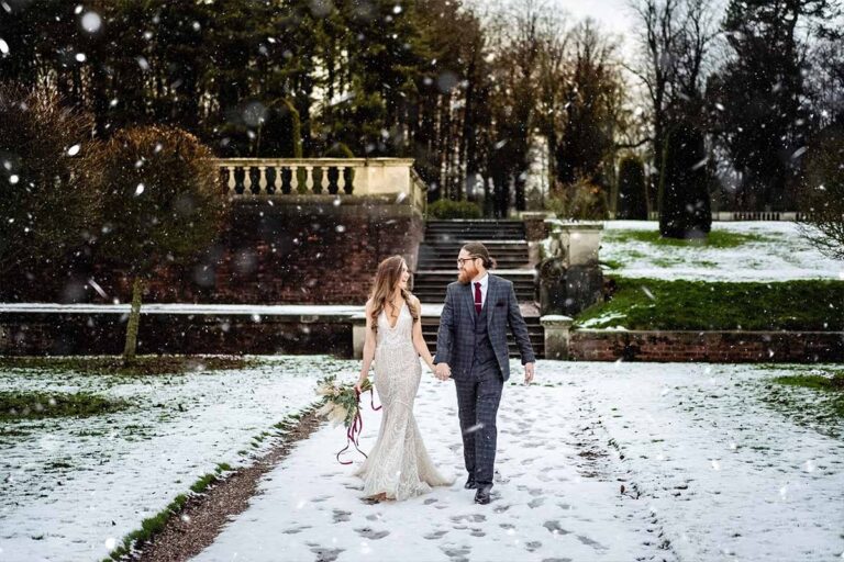 A couple in the snow on the garden steps, Knowsley Hall
