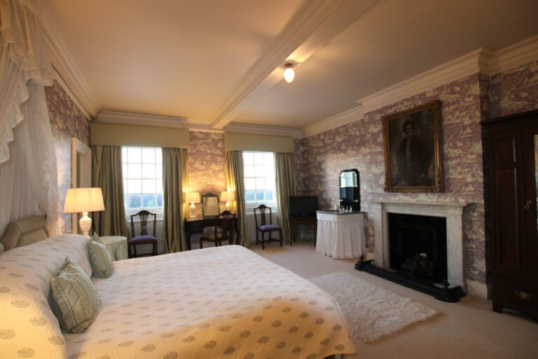 Lady Victoria's bedroom with a fireplace and tall windows, Knowsley Hall