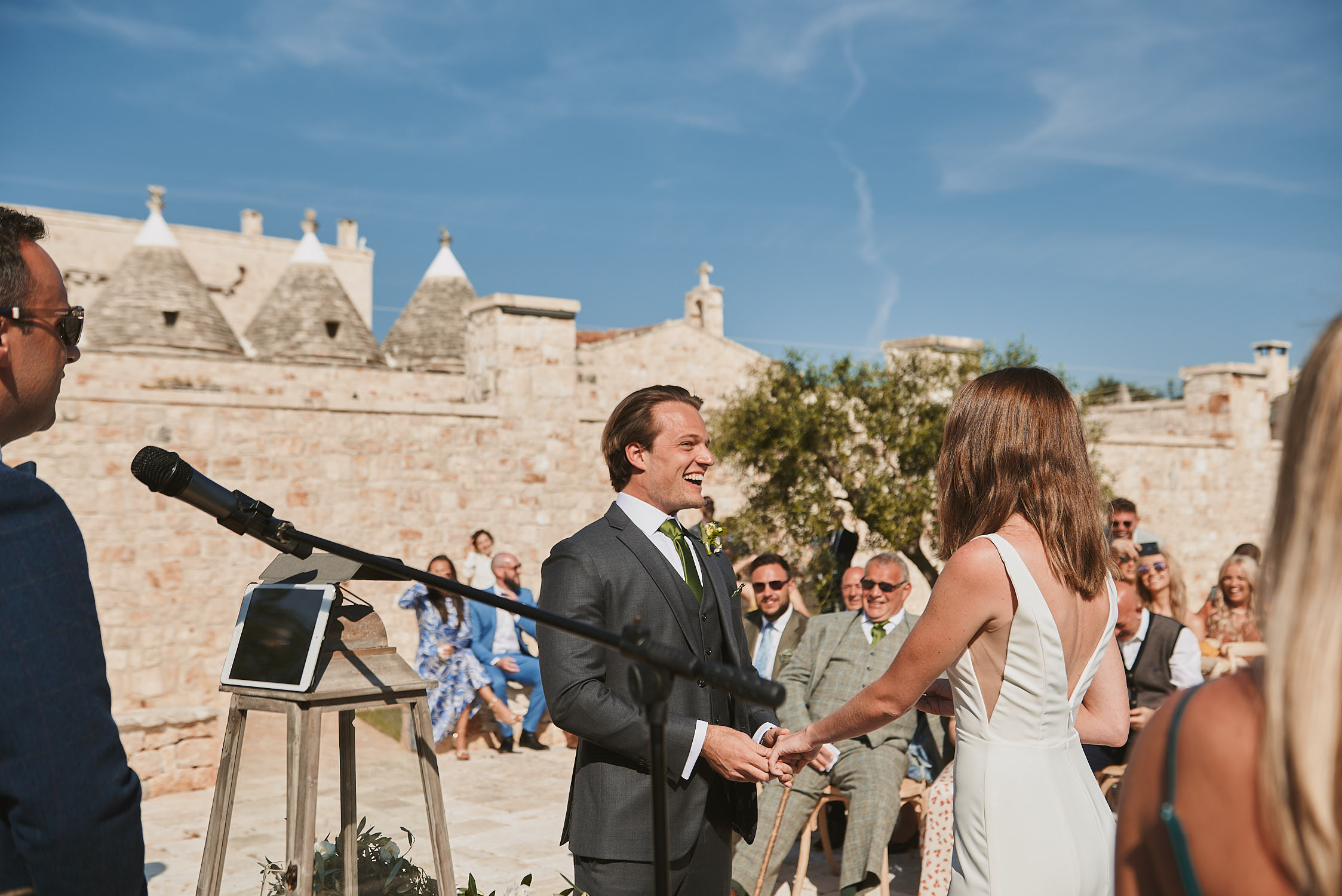 Open-air ceremony with trulli rooftops behind the couple, Puglia, La Bottega del Sogno