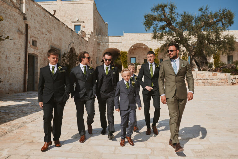 The groom and groomsmen crossing a masseria courtyard, Puglia, La Bottega del Sogno
