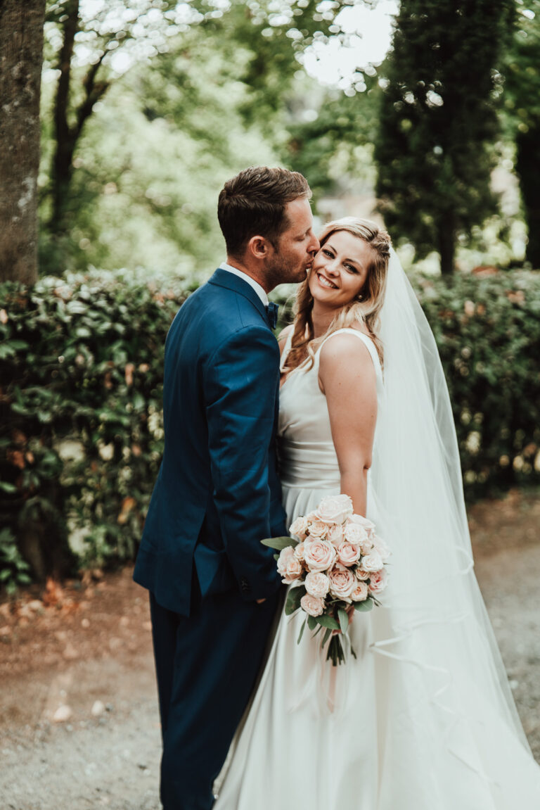 Bride and groom close together among the greenery, Tuscany, La Bottega del Sogno