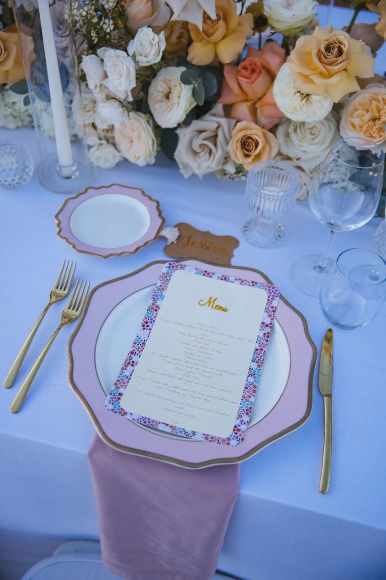 A place setting with a printed floral menu, pink-rimmed plates and gold cutlery, Villa Vettica, Amalfi Coast, La Calla Events
