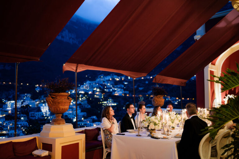 Dinner under a red awning above the lights of Positano, Palazzo Santa Croce, La Calla Events