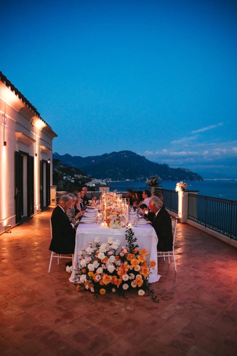 A long table on the terrace at blue hour, the coast lit beyond, Villa Vettica, Amalfi Coast, La Calla Events