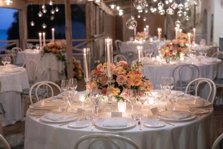 Round tables with coral and peach roses under hanging glass globes, Hotel Santa Caterina, Amalfi, La Calla Events