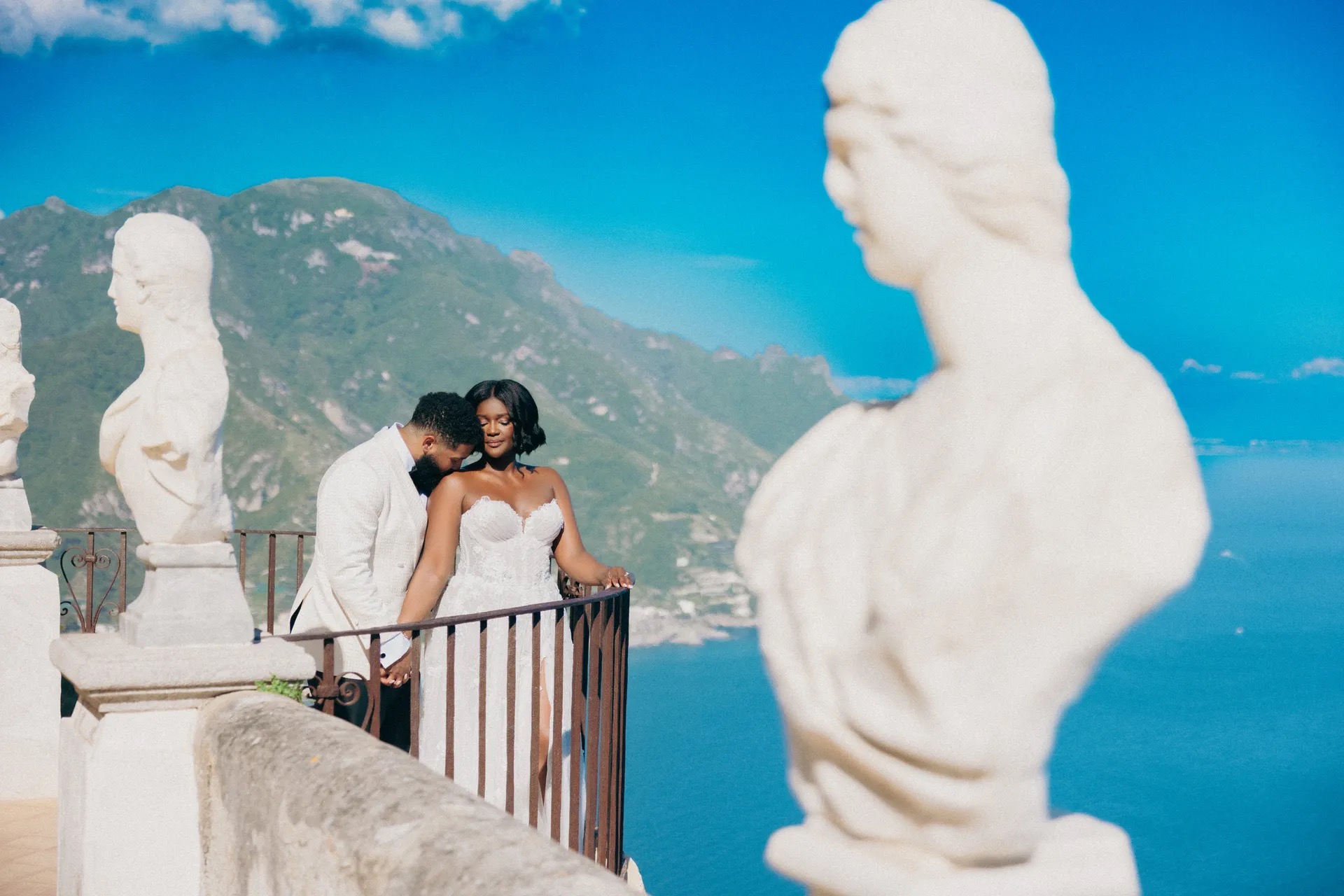 A couple between marble busts on a belvedere high above the sea, Amalfi Coast, La Calla Events