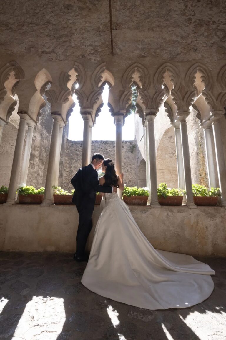 The couple beneath the interlaced arches of the cloister at Villa Rufolo, Ravello, La Calla Events