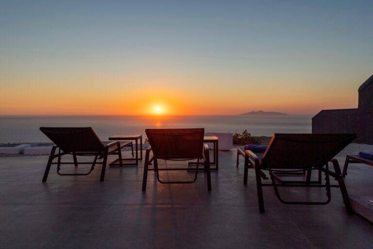 Double sun loungers on the terrace, turned to a sunset over the caldera and the far islands, La Maltese Estate