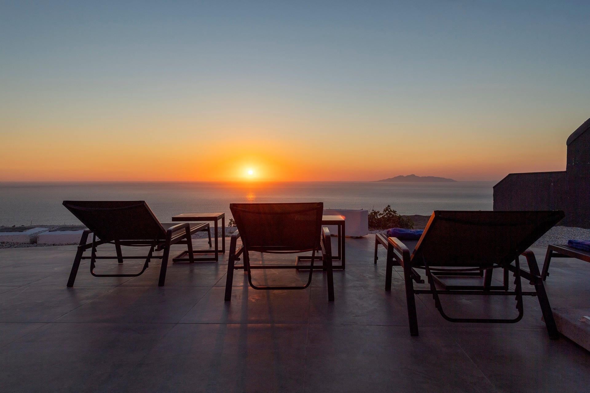 Double sun loungers on the terrace, turned to a sunset over the caldera and the far islands, La Maltese Estate