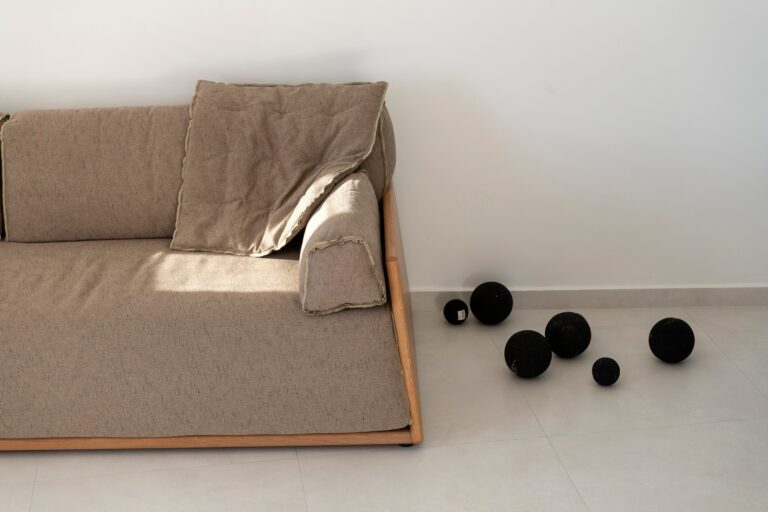 A linen daybed dressed with black stone spheres, a study in Cycladic calm, La Maltese Estate