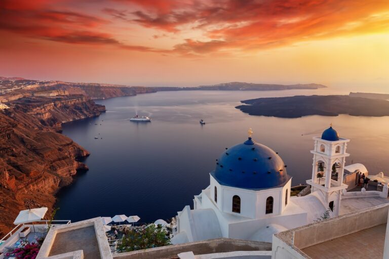 A blue-domed church above the caldera as the sun goes down, La Maltese Estate