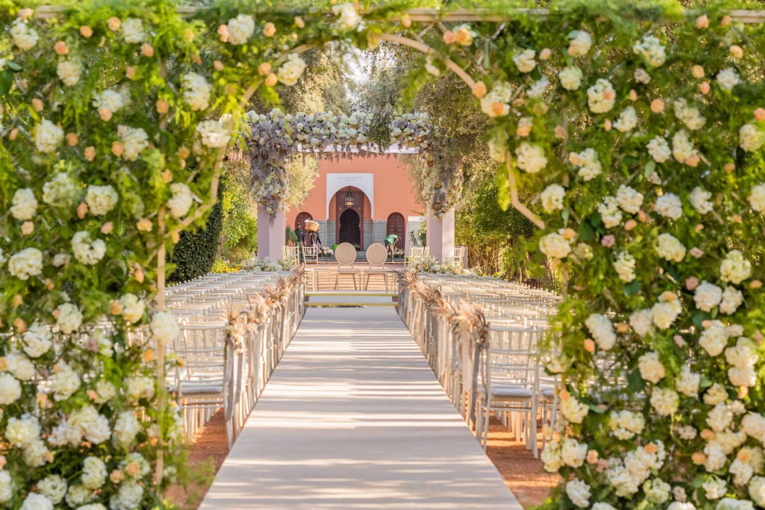 A wedding ceremony set up in the gardens facing Le Menzeh