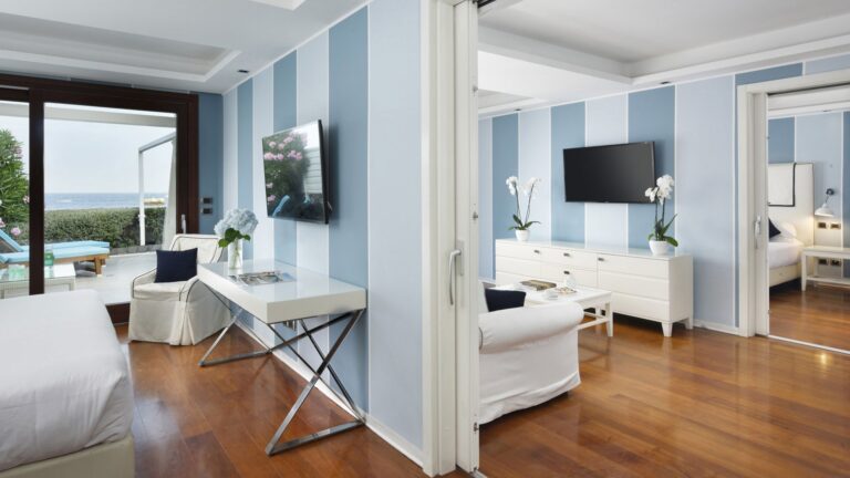 A bright blue-and-white suite with connecting rooms and sea views, La Plage Resort