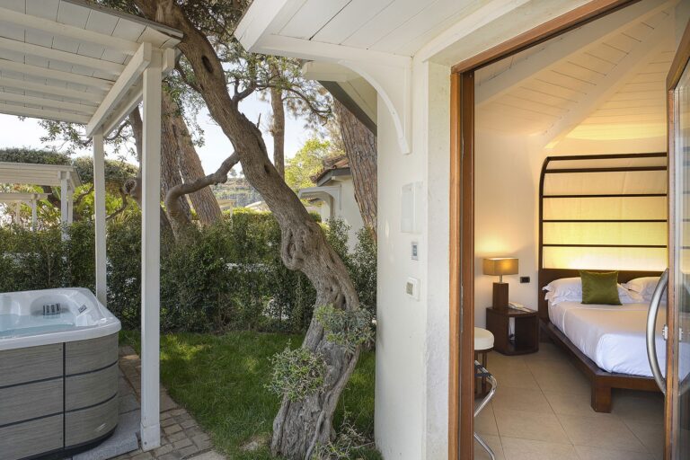 A garden room with a private jacuzzi set beneath an ancient olive tree, La Plage Resort