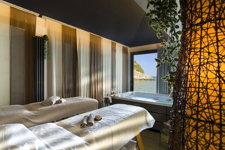 A Thalea spa treatment room with twin beds and a jacuzzi at a sea-view window, La Plage Resort