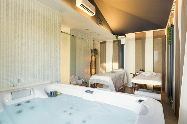 The spa, a jacuzzi and twin massage beds in warm light, La Plage Resort
