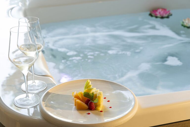 A private jacuzzi set with two glasses of wine and a dessert, La Plage Resort